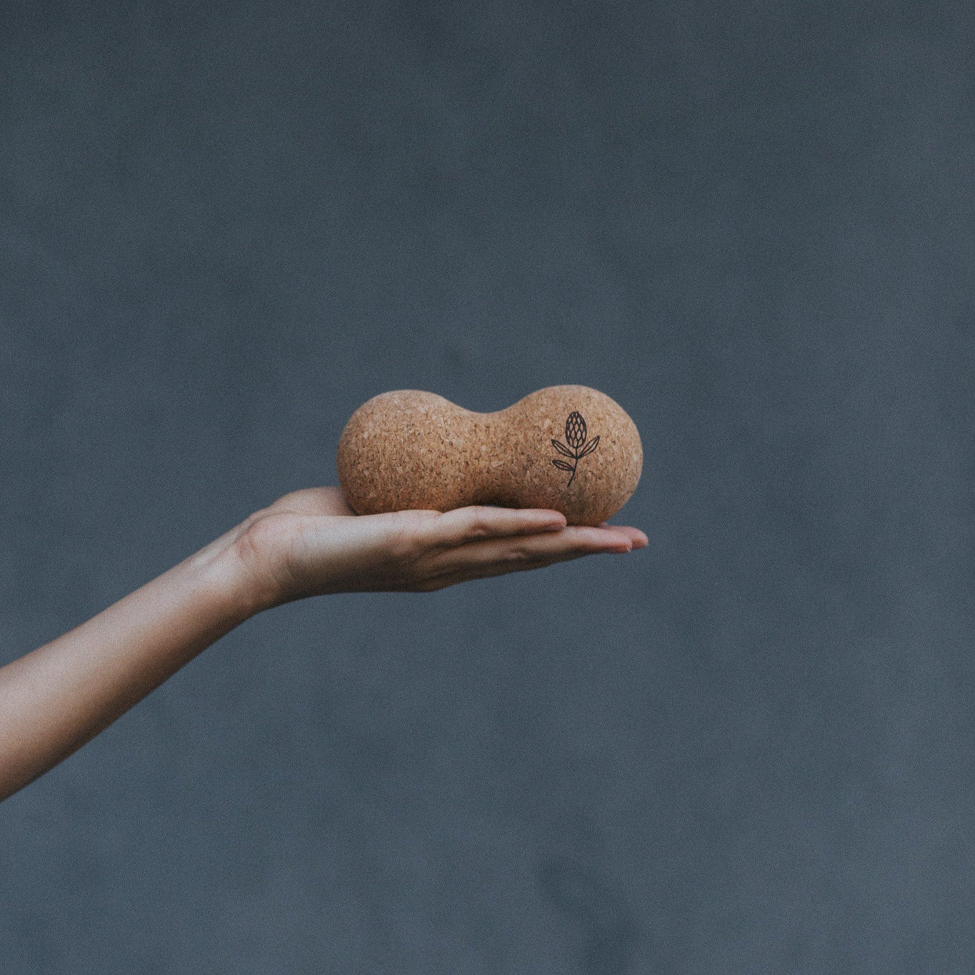 Hand holding a cork yoga ball