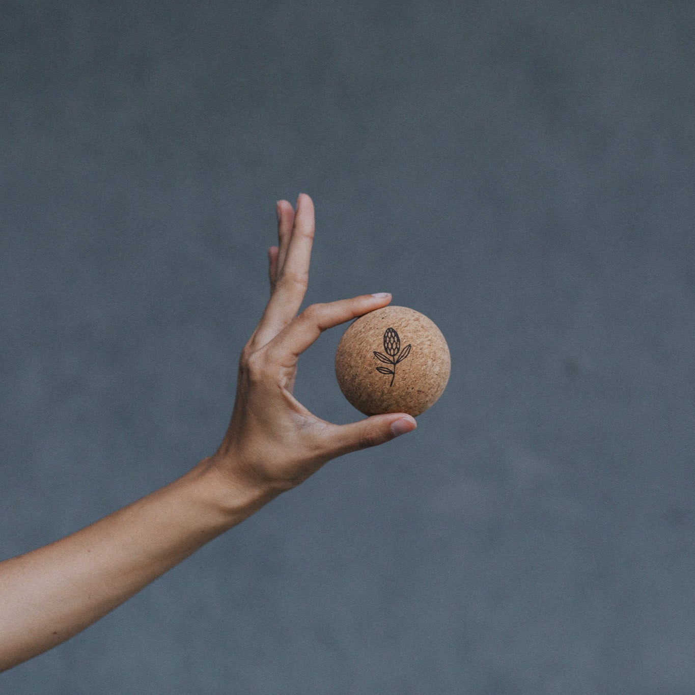 Hand holding a cork massage ball