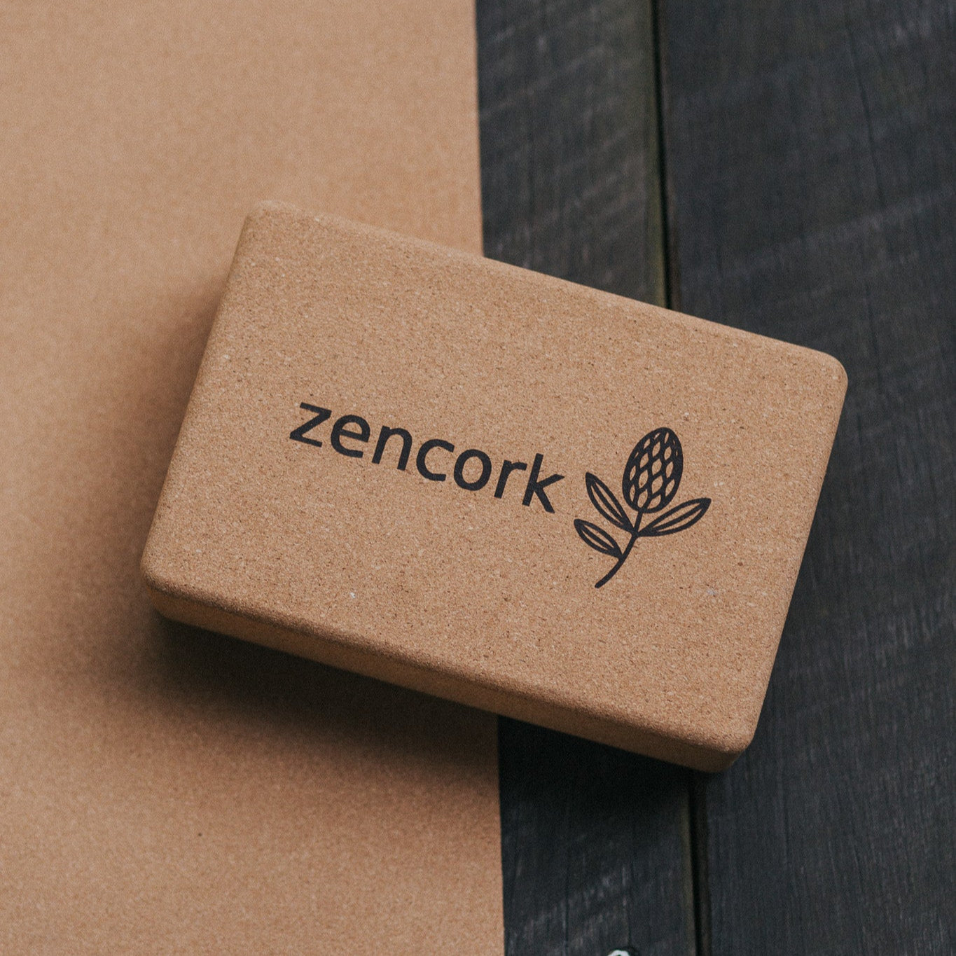 Brown cork block with 'zencork' branding on a wooden surface