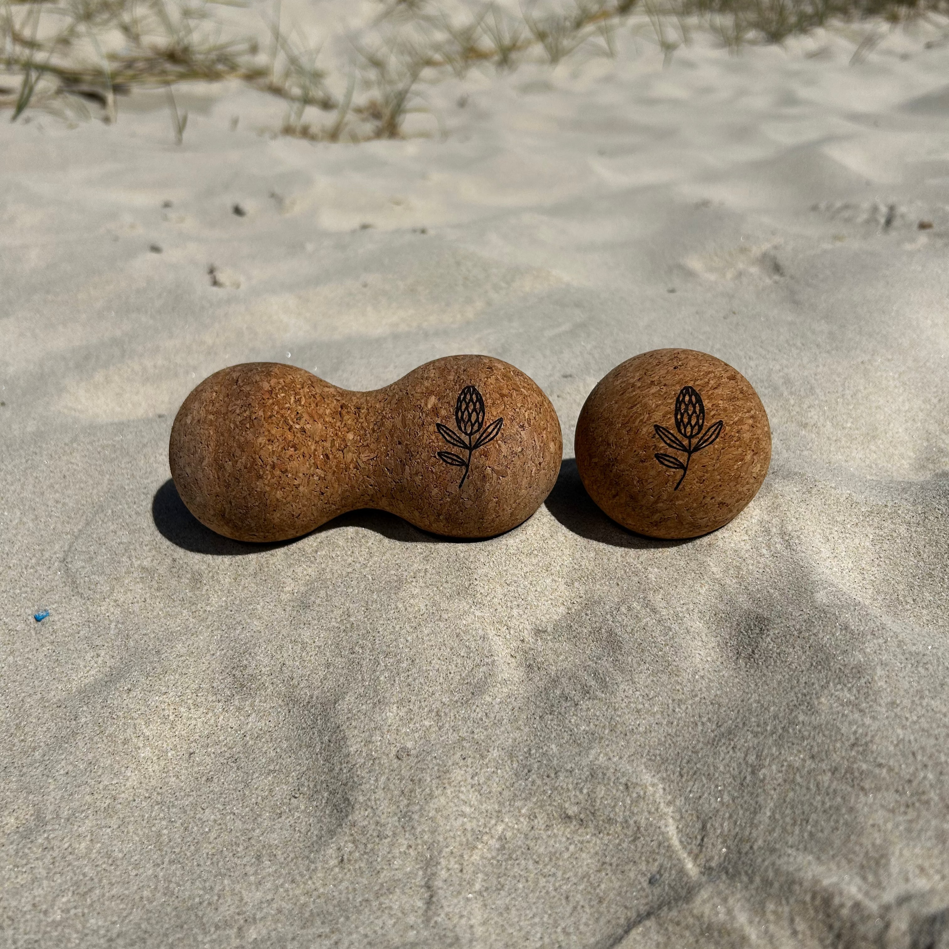two cork balls on a sandy beach