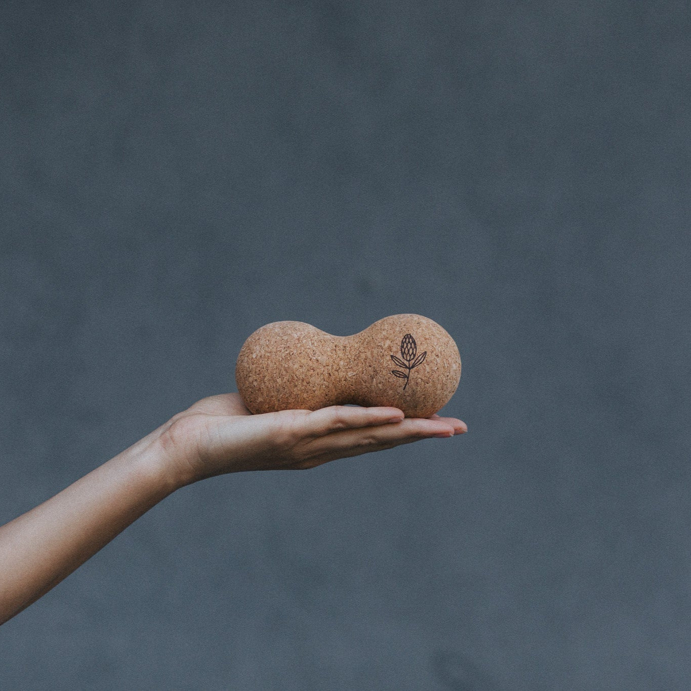 Hand holding a cork massage ball 
