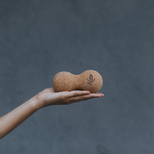 Hand holding a cork massage ball 