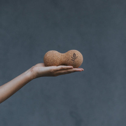 Hand holding a cork yoga ball