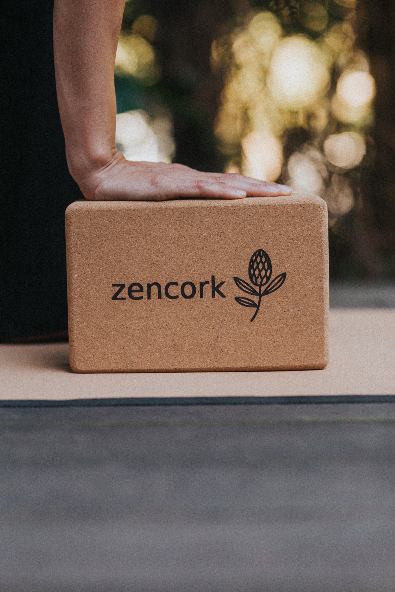 Yoga block with 'zencork' branding on a yoga mat
