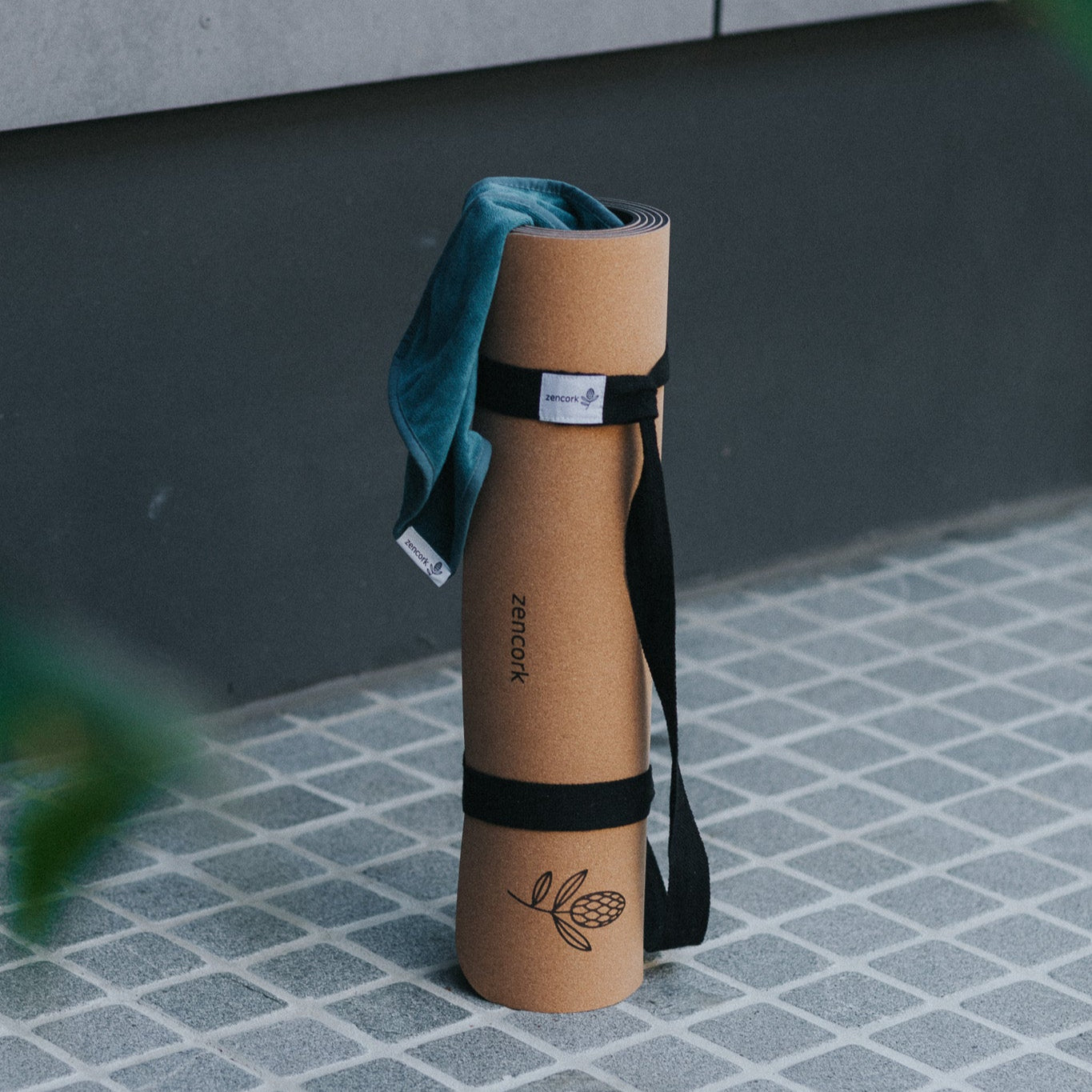Yoga mat with strap on a tiled floor